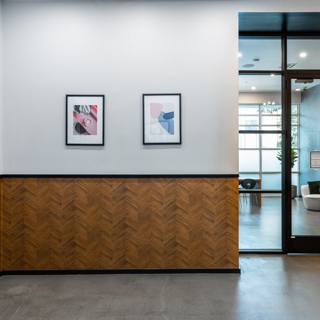 Domain Oakland Apartments - art displayed in gallery leading to Connect Cafe