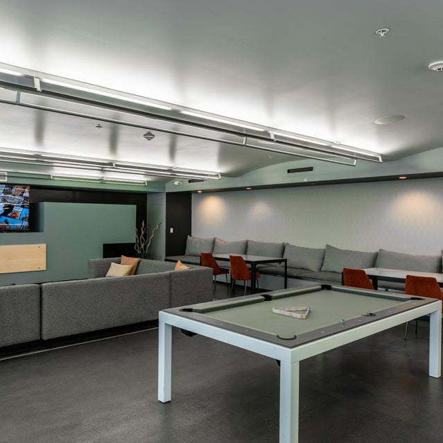 Domain Oakland Apartments - clubhouse with pool table and TV entertainment area