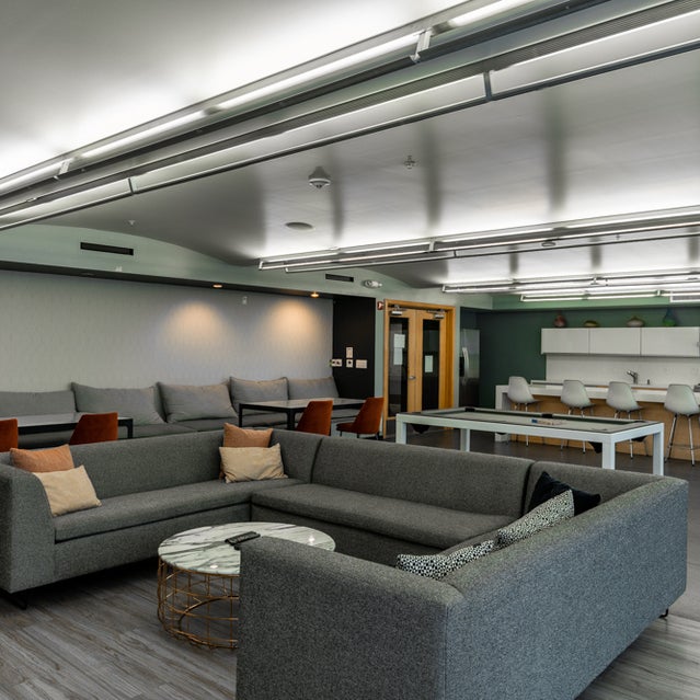 Domain Oakland Apartments - clubhouse with large sofa and pool table