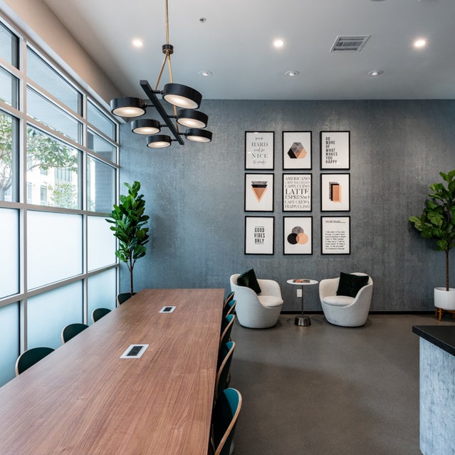 Domain Oakland Apartments - Connect Cafe coworking area with tables and chairs