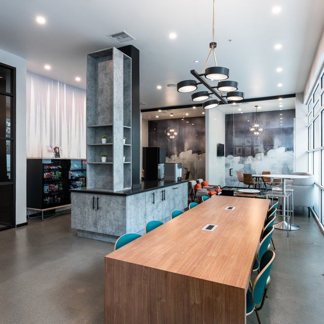 Domain Oakland Apartments - Connect Cafe coworking area with tables and chairs