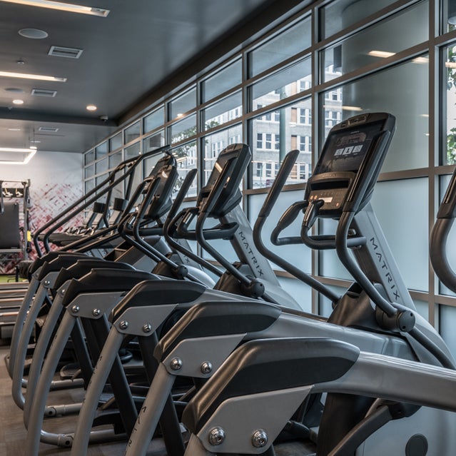 Domain Oakland Apartments - fitness center with cardio equipment, weight lifting machines, and free weights