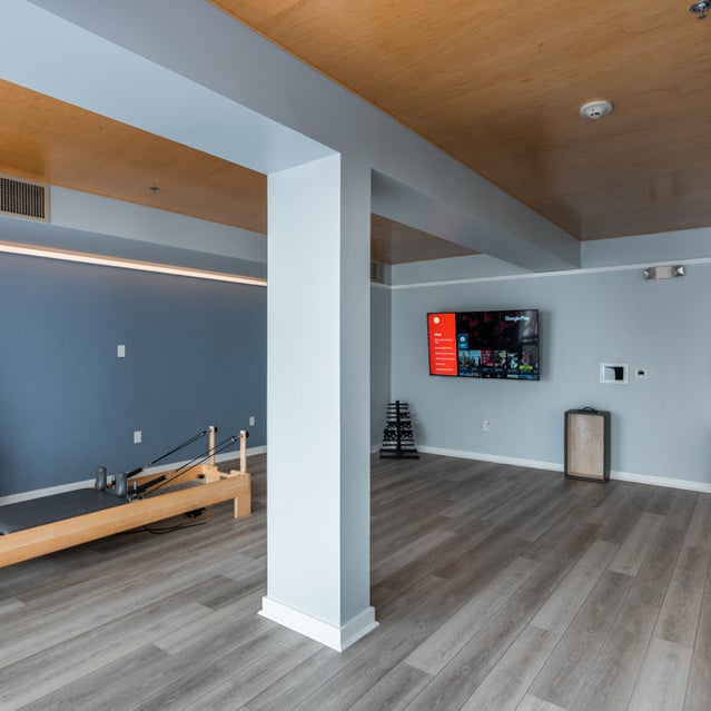 Domain Oakland Apartments - yoga studio with pilates equipment and on-demand fitness