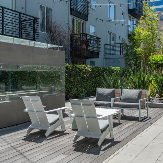 Domain Oakland Apartments - courtyard seating area with firepit