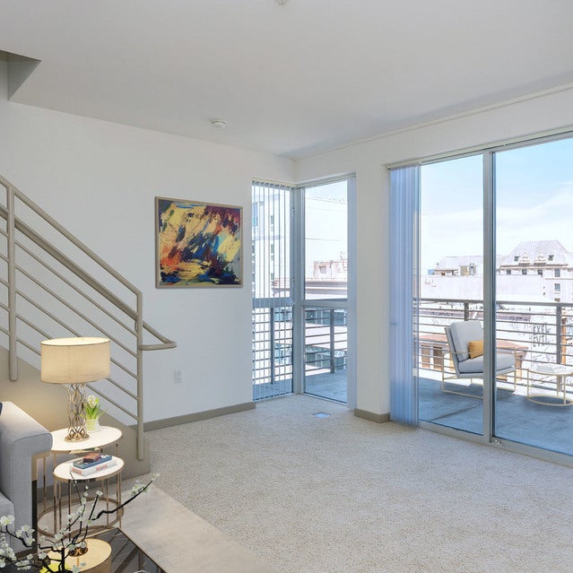 Domain Oakland Apartments - living area leading to second level and balcony